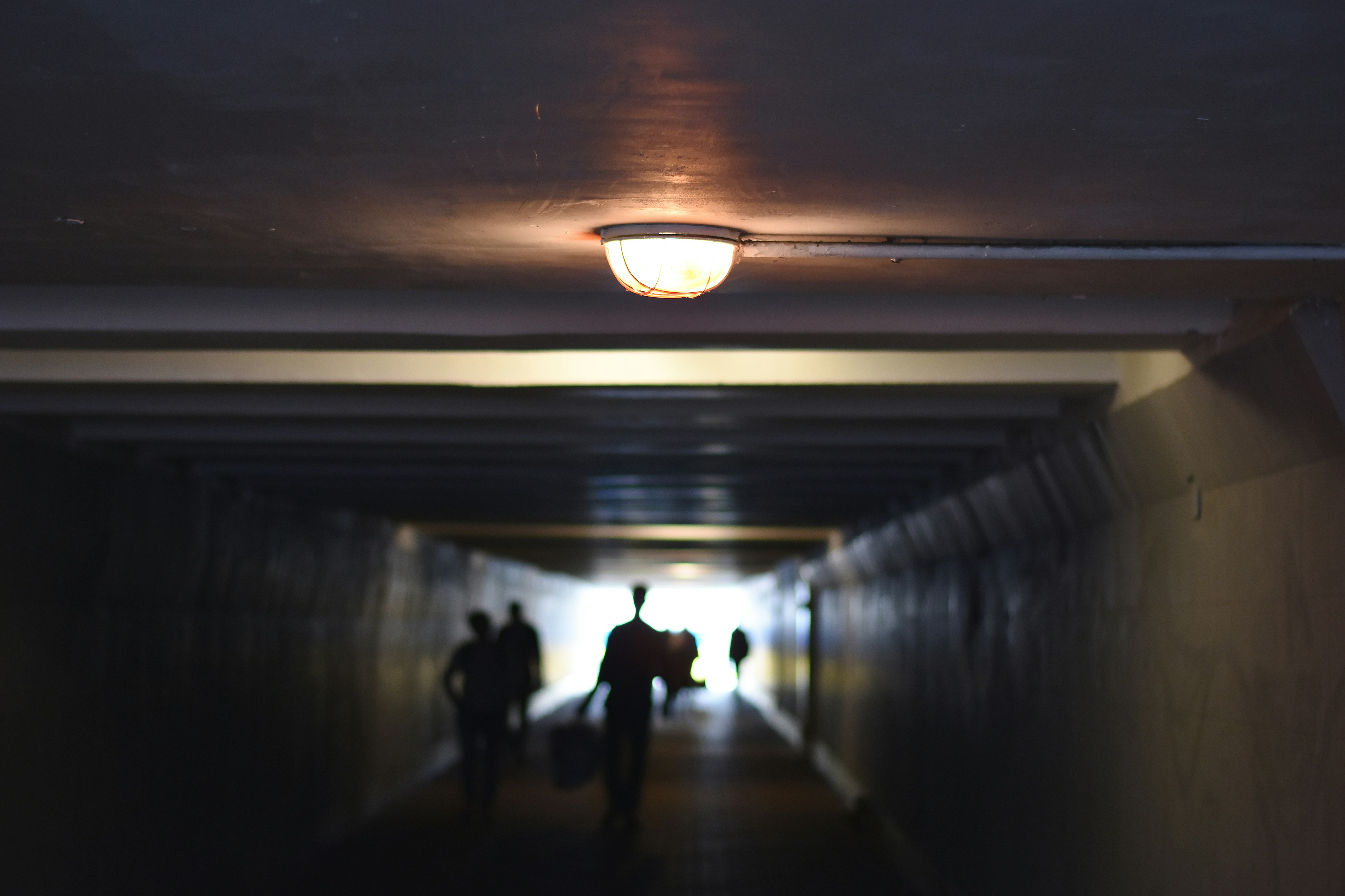 people walking inside tunnel